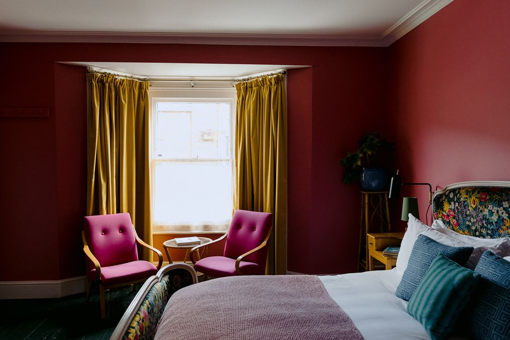 Image may contain Furniture Chair Room Bedroom Indoors Bed Interior Design and Living Room