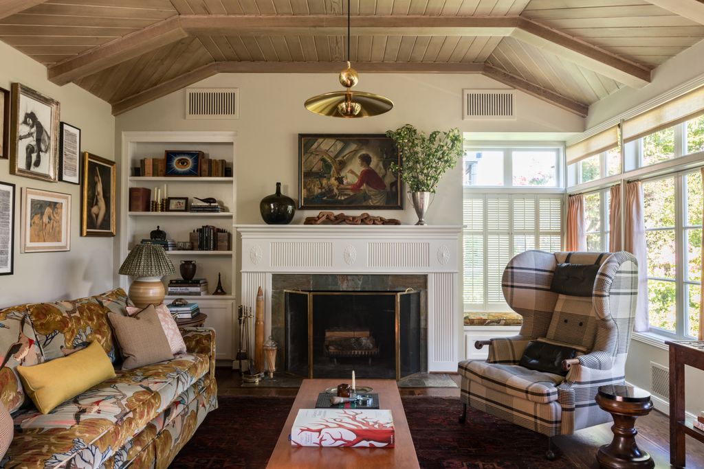 Image may contain Fireplace Indoors Living Room Room Interior Design Furniture Home Decor Hearth Flooring and Human