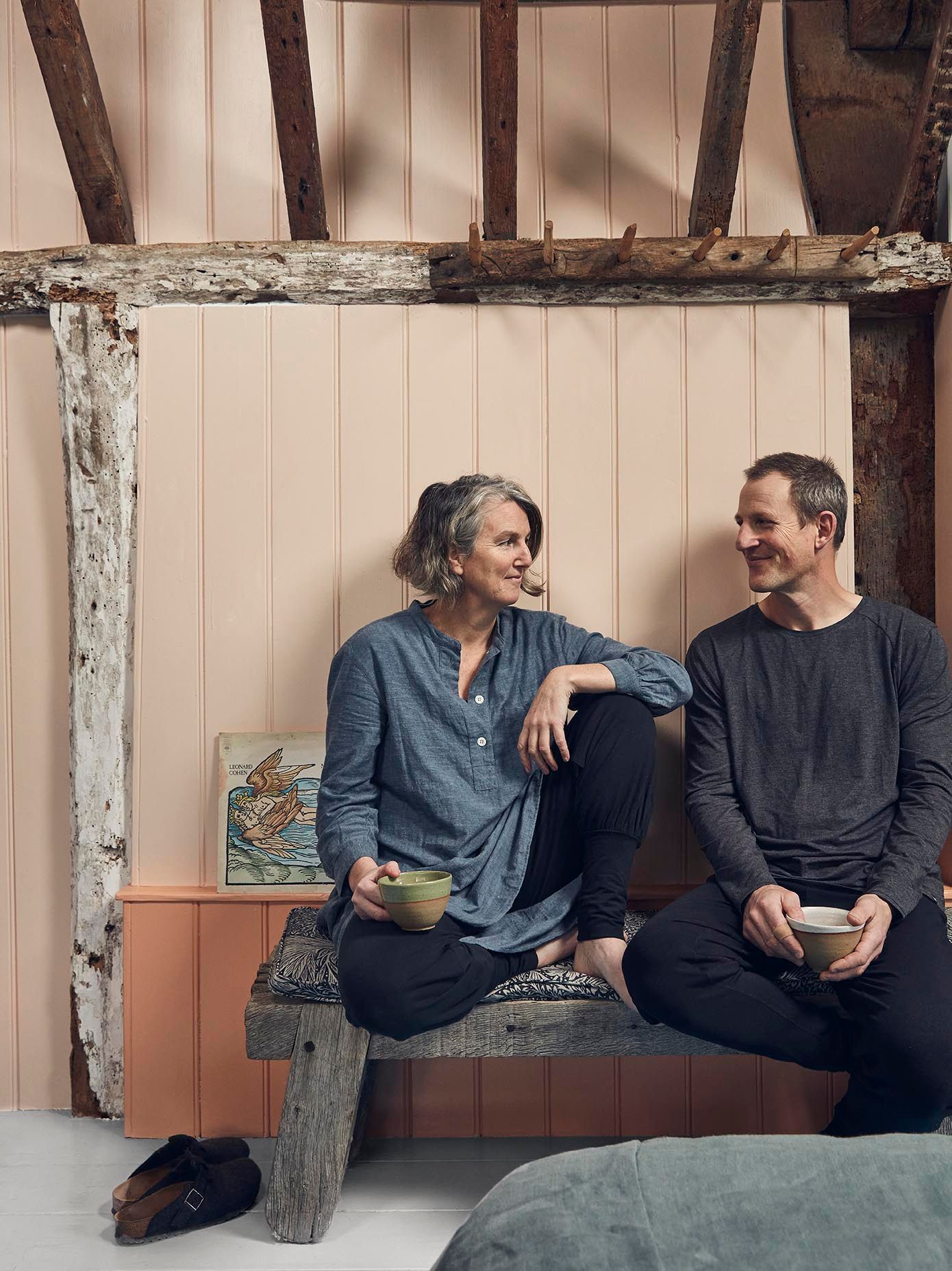 Image may contain Human Person Clothing Apparel Sitting Furniture Couch Pants and Wood