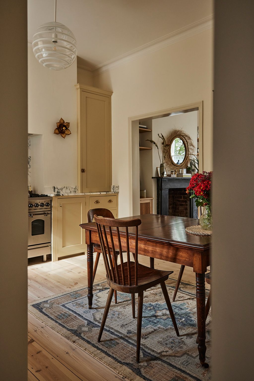 A vintage 18thcentury extendable English table is paired with vintage English spindle back chairs and vintage German...