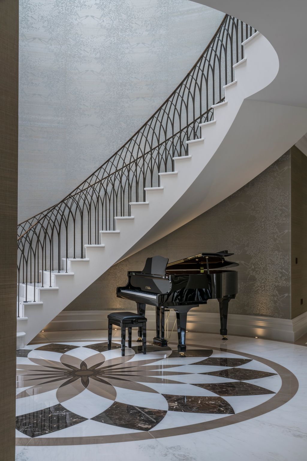 Alexander James Interiors placed the grand piano below the elegant staircase in this Surrey mansion. Bespoke marble...