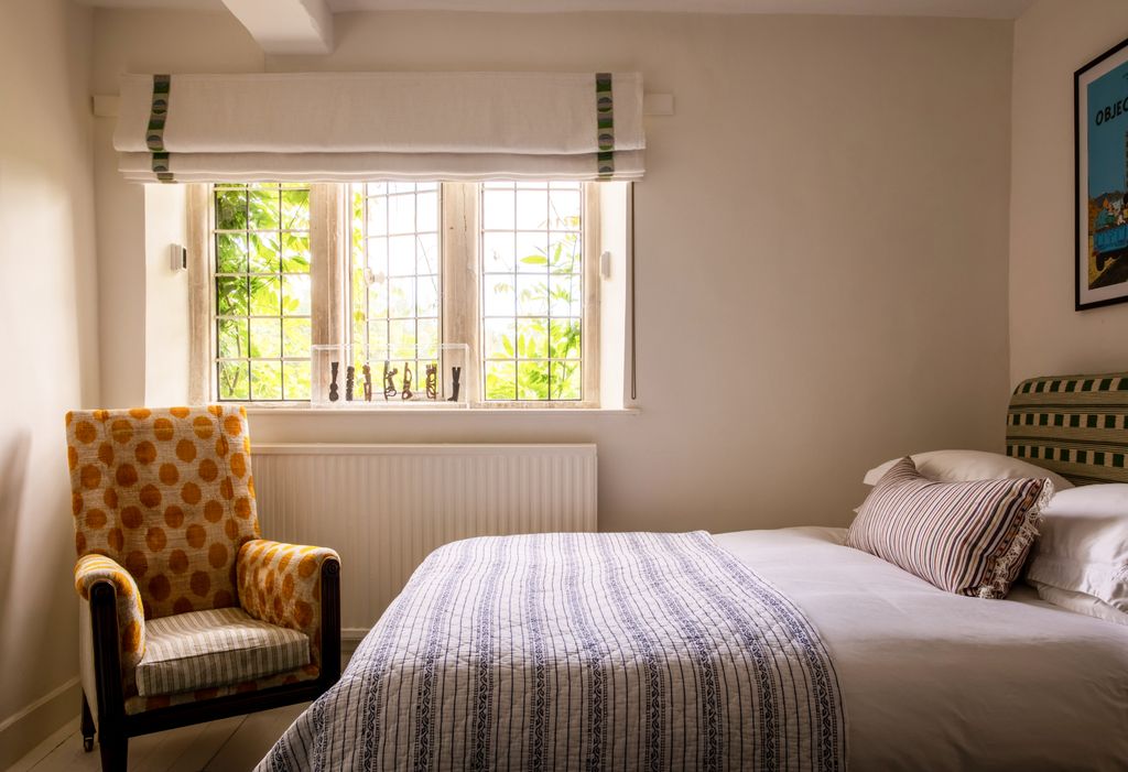 Image may contain Indoors Room Bedroom Furniture Bed Chair and Cushion