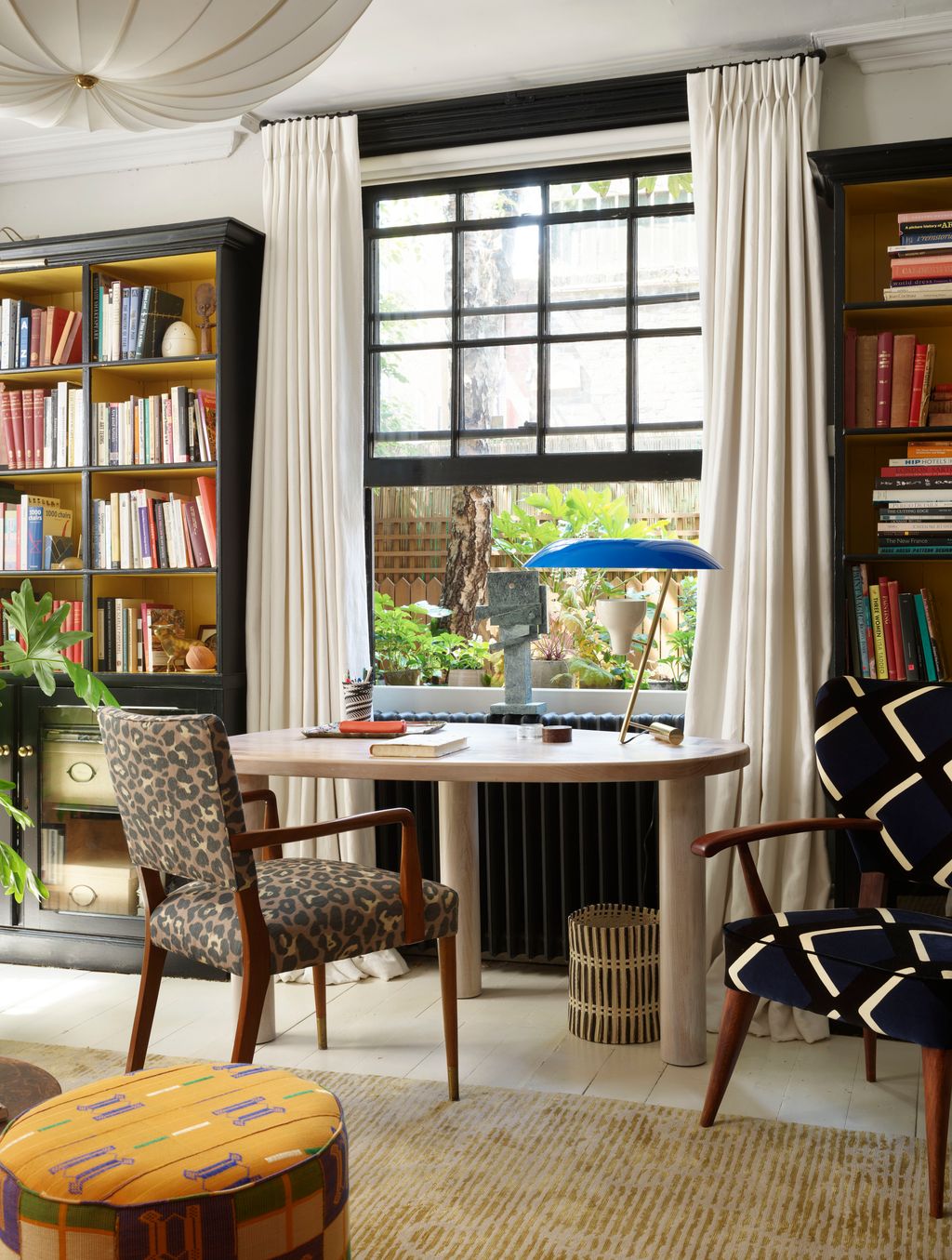 Image may contain Furniture Chair Bookcase Shelf Indoors Room Table and Living Room