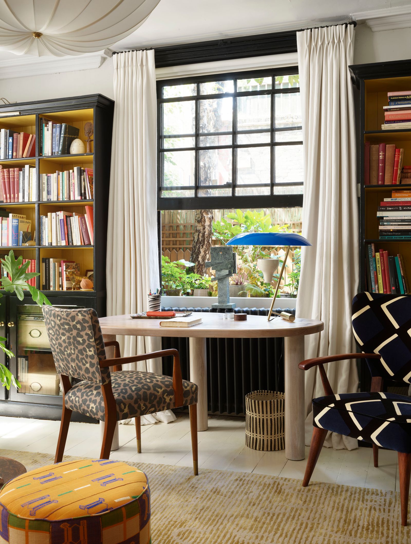 Image may contain Furniture Chair Bookcase Shelf Indoors Room Table and Living Room