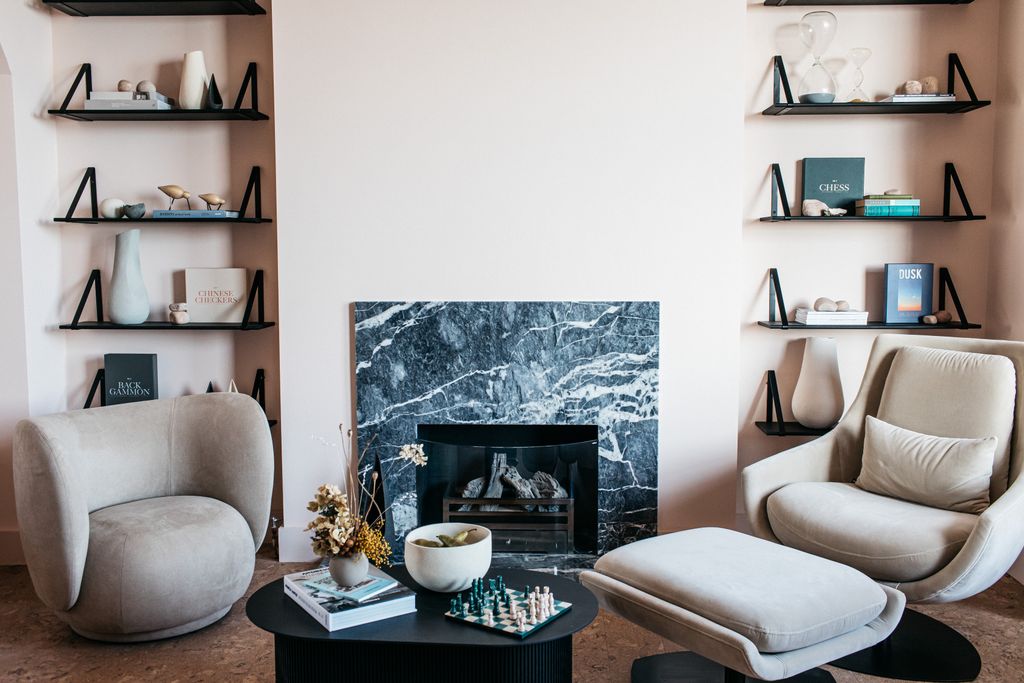 Image may contain Furniture Living Room Room Indoors Table Interior Design Coffee Table Shelf and Fireplace