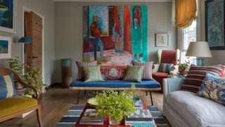 Image may contain Living Room Room Indoors Furniture Couch Human Person Table Cushion and Interior Design