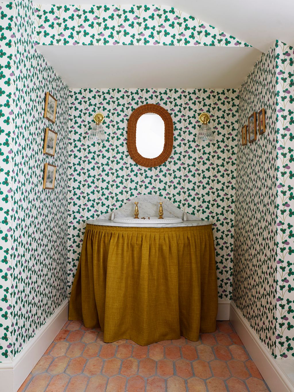The downstairs powder room is enriched by a vibrant floral wallpaper and a Frenchstyle vanity.