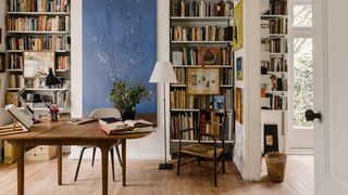 Image may contain Furniture Bookcase Shelf Chair Room Indoors Living Room Wood Interior Design Flooring and Book