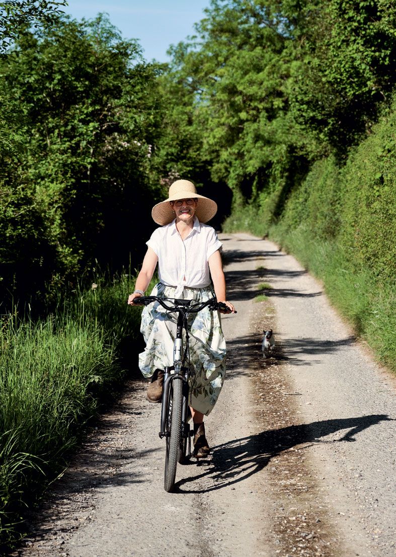 Ali cycles along the track to the house