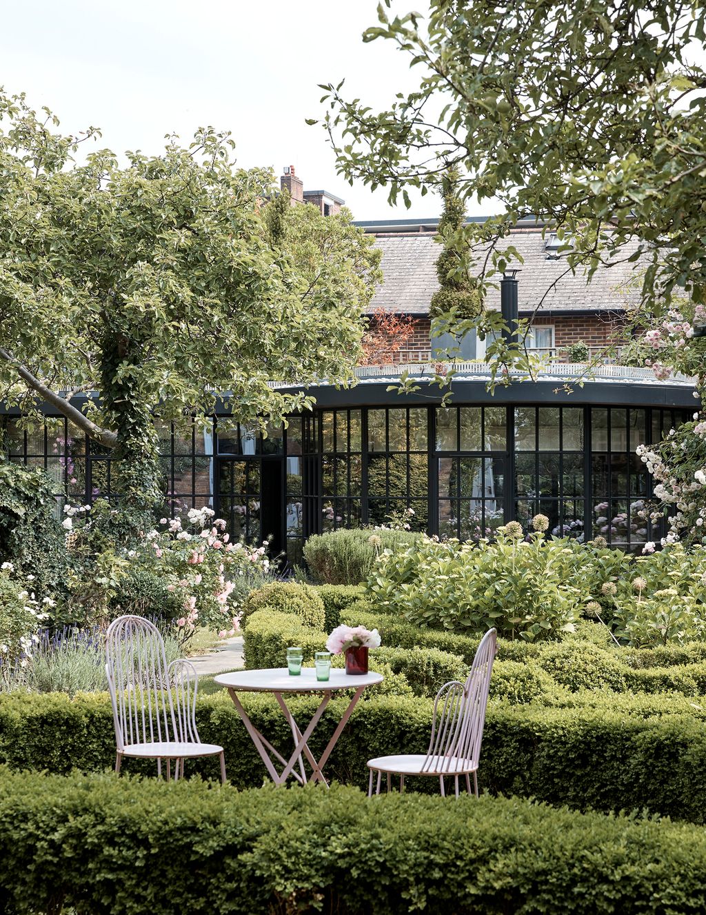 Image may contain Furniture Chair Outdoors Grass Plant Patio Porch Garden Arbour and Pergola