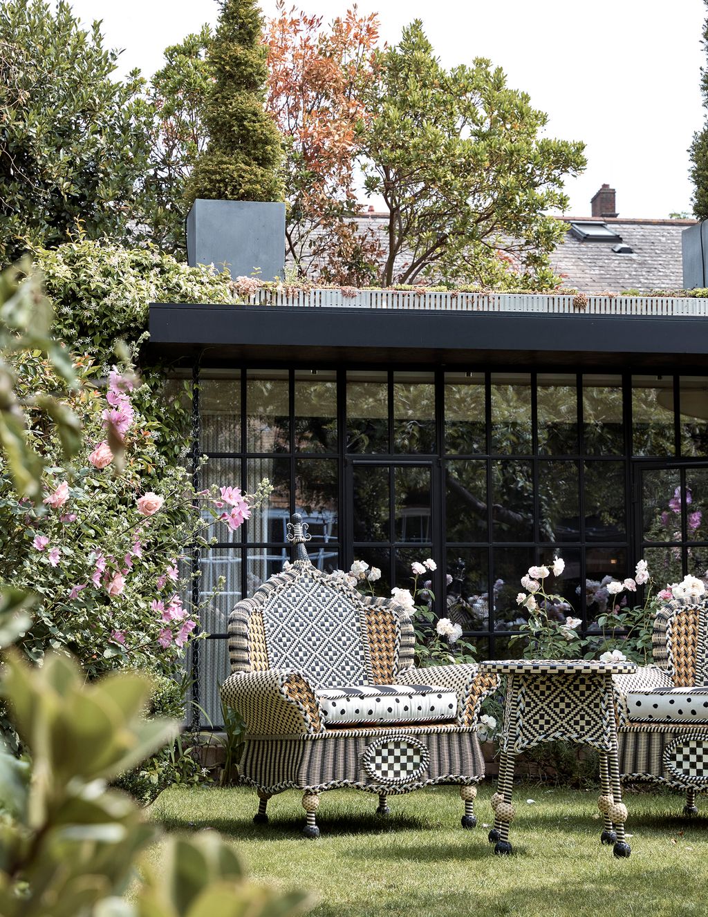 Image may contain Outdoors Patio Garden Arbour Porch Plant Furniture Bush and Vegetation