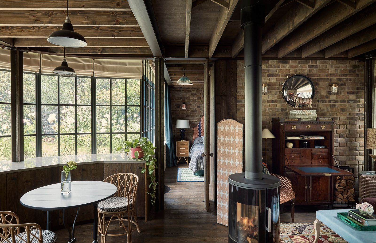 Image may contain Furniture Chair Floor Flooring Human Person Wood Indoors Interior Design Hardwood and Table