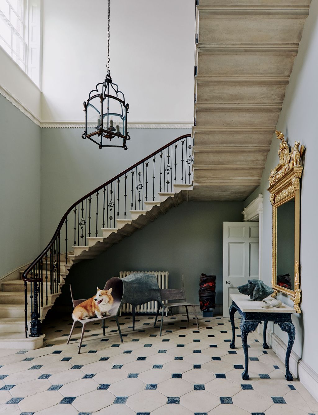 Image may contain Interior Design Indoors Staircase Banister Handrail Living Room Room Flooring Animal and Dog