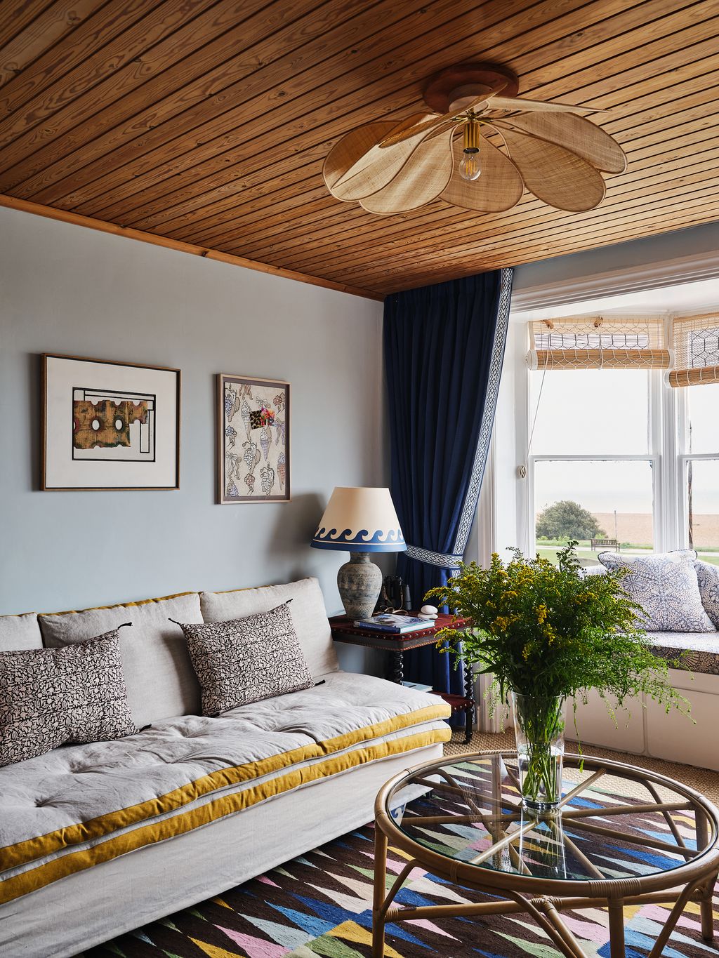 Image may contain Living Room Indoors Room Furniture Appliance Ceiling Fan and Couch