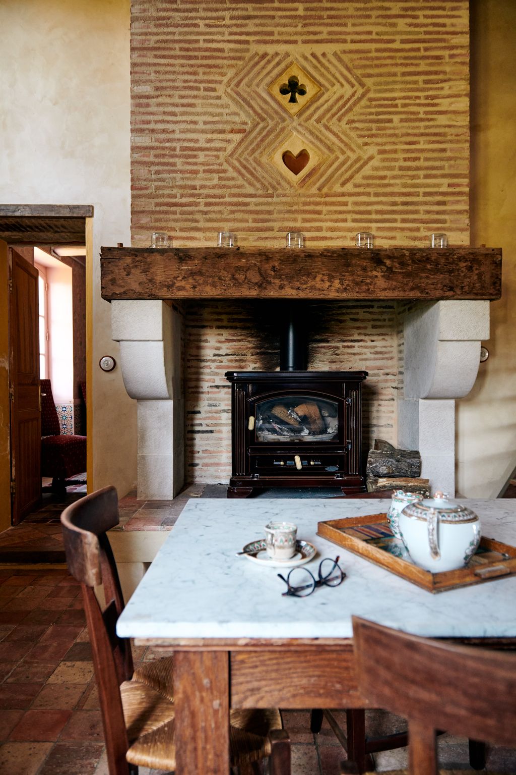 Image may contain Furniture Chair Fireplace Indoors Hearth Wood and Hardwood