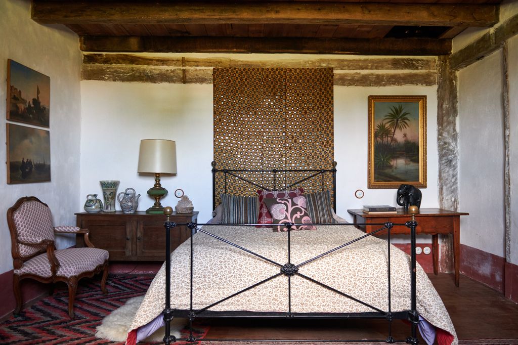 Image may contain Furniture Interior Design Indoors Room Bedroom Chair Bed Flooring Rug Electronics and Screen