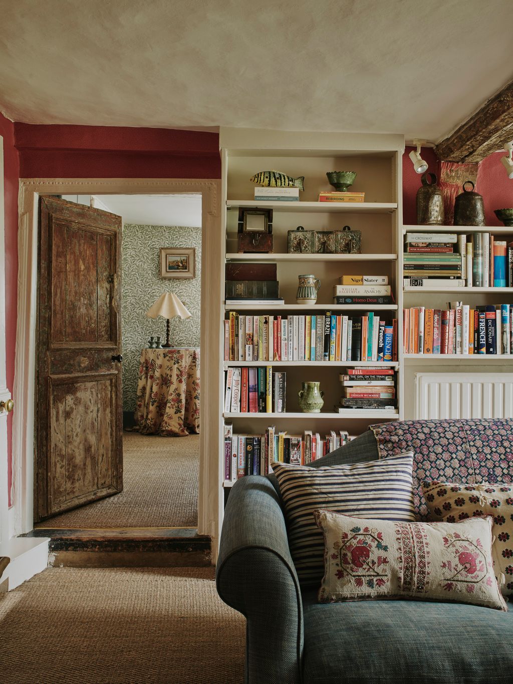 Image may contain Furniture Bookcase Shelf Couch Cushion Living Room Indoors and Room