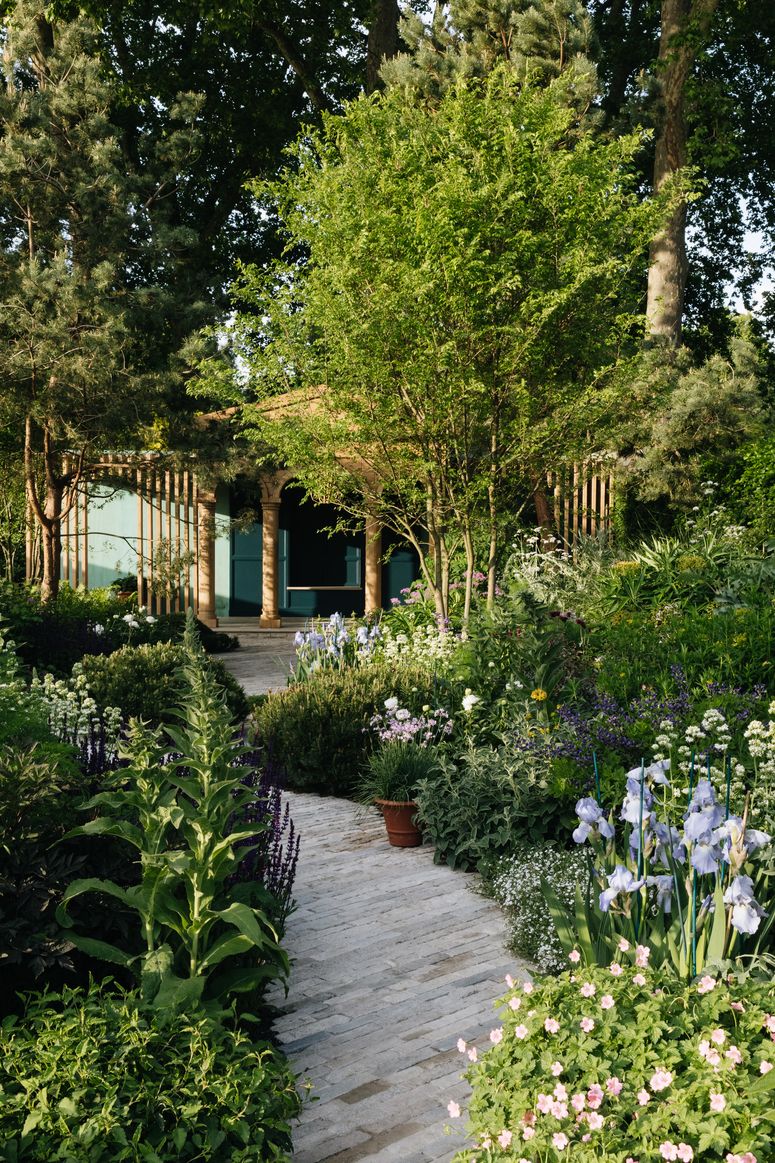 Image may contain: Outdoors, Garden, Arbour, Plant, Vase, Pottery, Potted Plant, Jar, and Porch