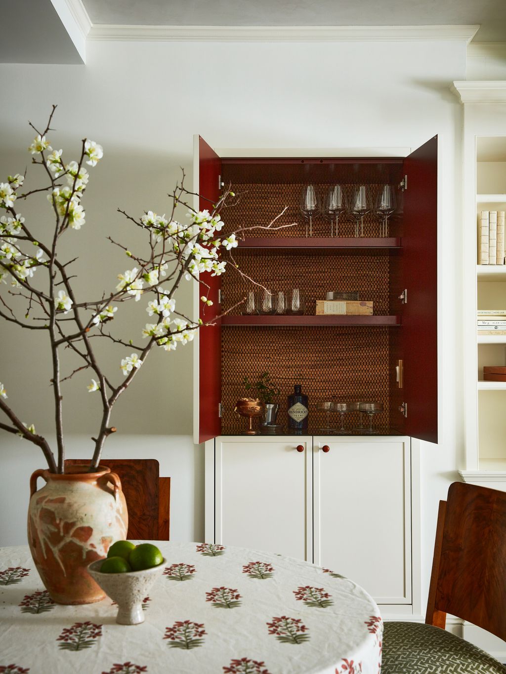 Image may contain Furniture Dining Table Table Plant Shelf Cupboard Closet Home Decor Flower Blossom and Cabinet