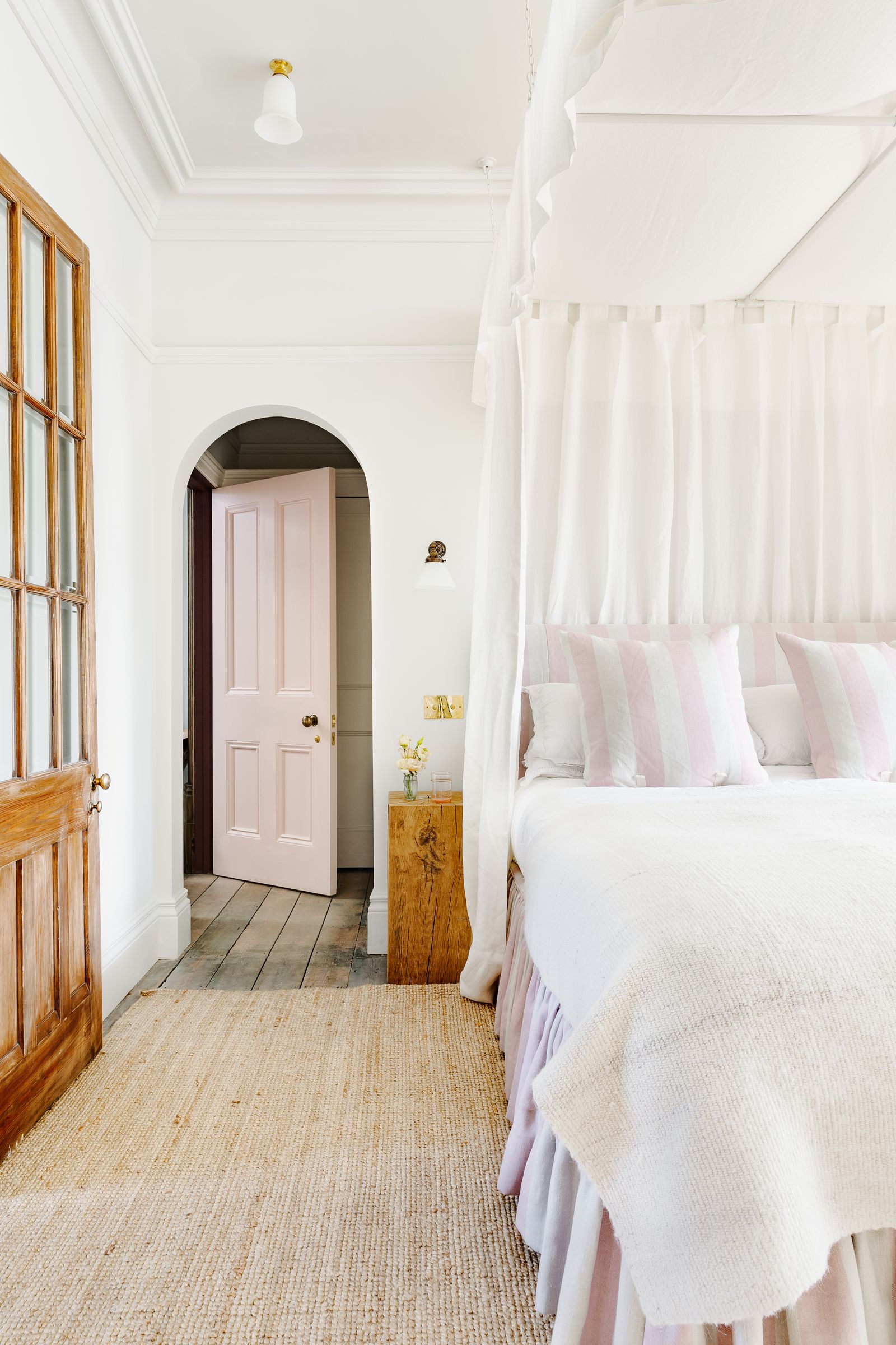 Image may contain Room Bedroom Indoors Interior Design Wood Furniture Bed Hardwood Corner Floor and Housing