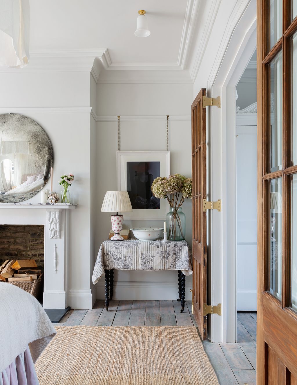 Image may contain Living Room Room Indoors Interior Design Furniture Wood Flooring Human Person and Home Decor