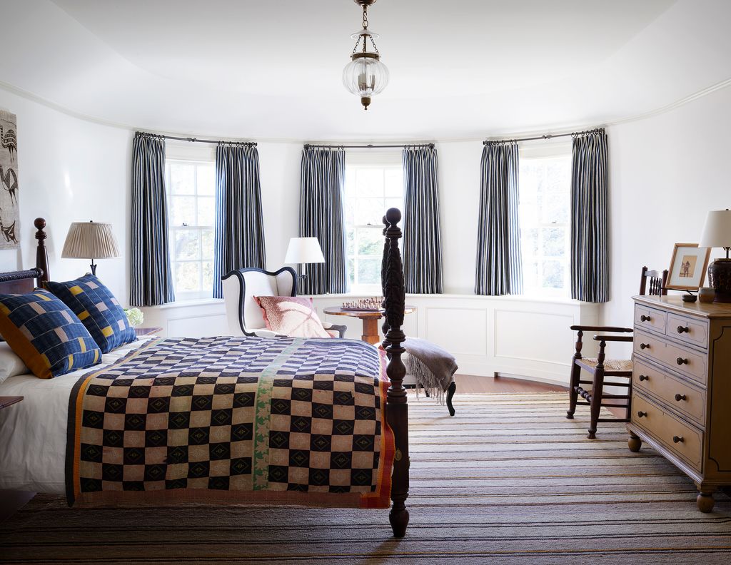 Image may contain Furniture Room Bedroom Indoors Wood Flooring Hardwood Interior Design Floor Bed and Living Room