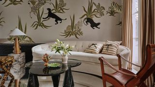 Image may contain Living Room Room Indoors Furniture Table Coffee Table Interior Design Chair Couch and Animal