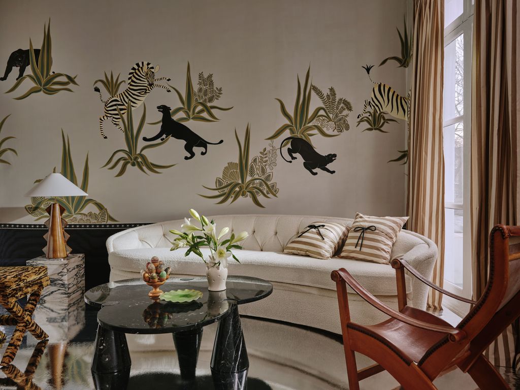 Image may contain Living Room Room Indoors Furniture Table Coffee Table Interior Design Chair Couch and Animal