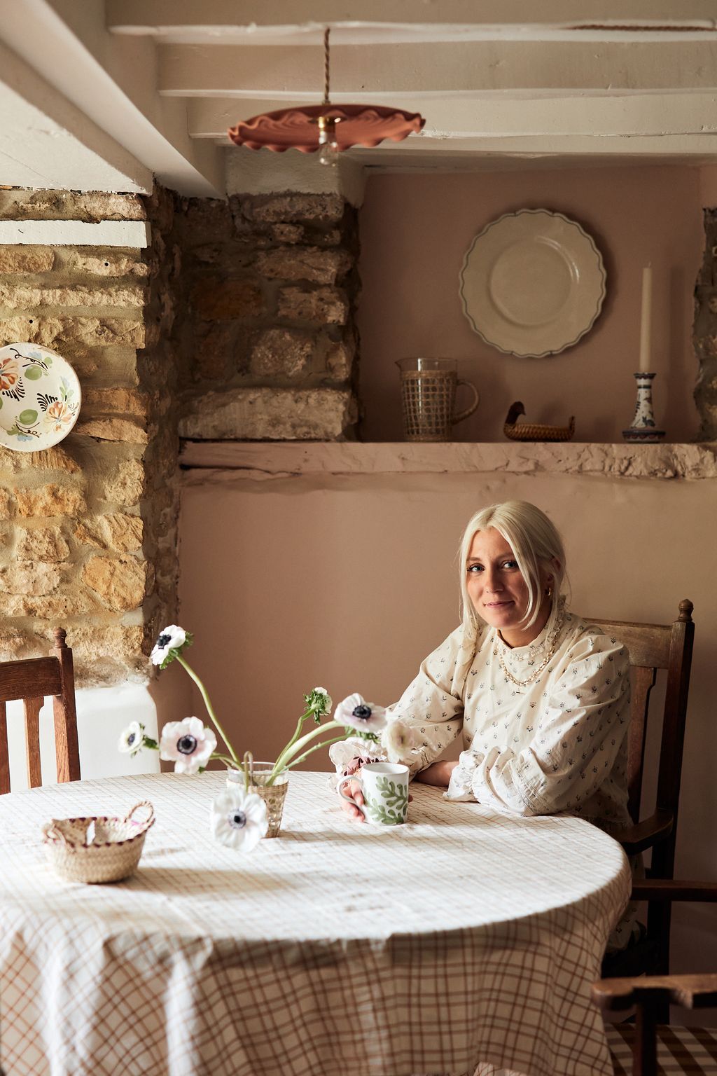 Image may contain Home Decor Furniture Human Person Table Linen Dining Table Room and Indoors