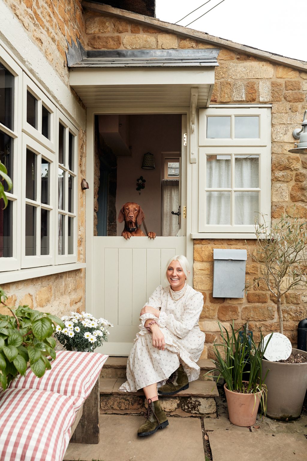 Image may contain Home Decor Human Person Plant Vase Pottery Potted Plant Jar Flower Blossom Window and Porch