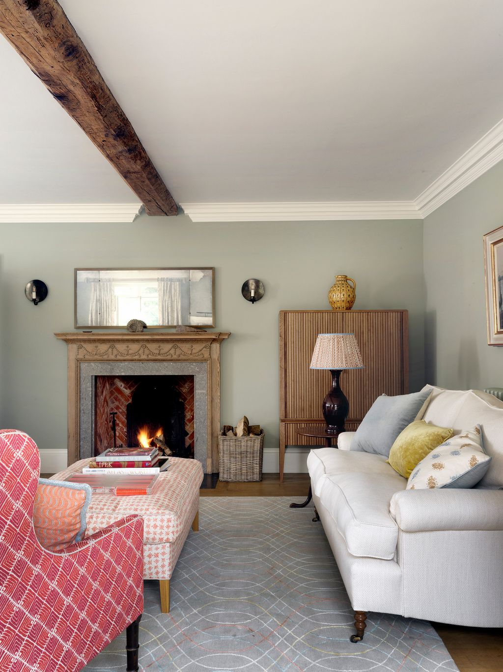 Image may contain Living Room Room Indoors Furniture Couch Fireplace Interior Design Hearth Home Decor and Cushion