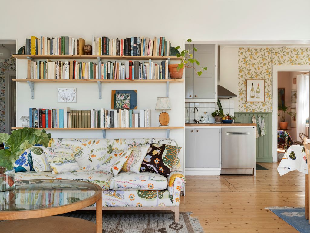 Image may contain Furniture Living Room Room Indoors Table Couch Interior Design Wood Shelf and Coffee Table