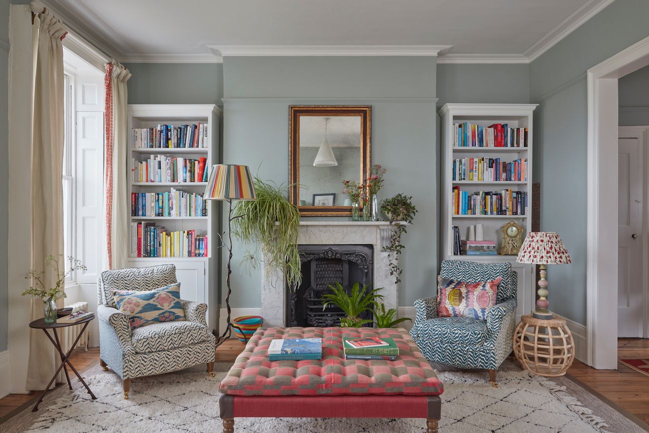 Image may contain Furniture Living Room Indoors Room Interior Design Couch Bookcase Cushion and Rug