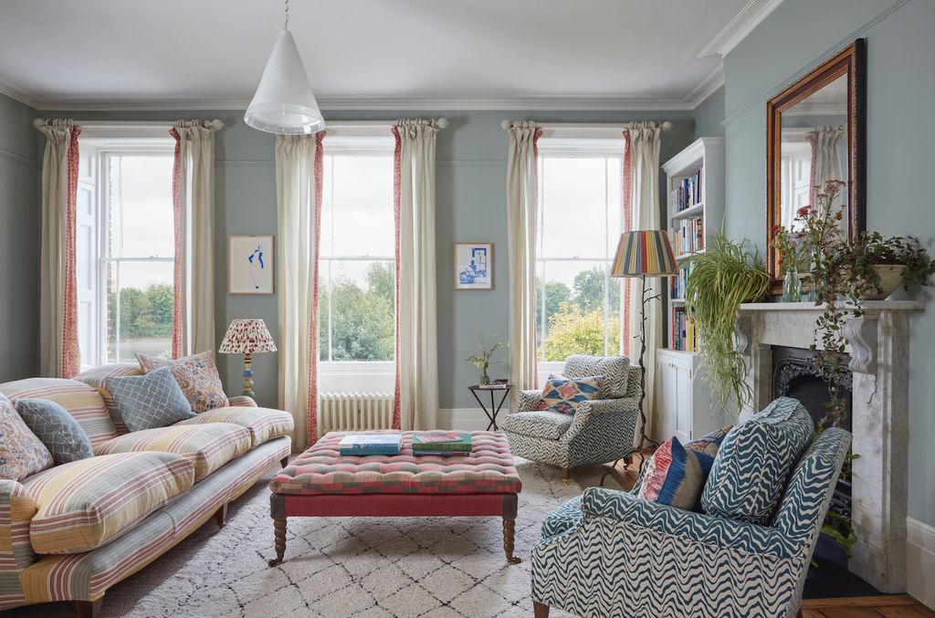 Image may contain Furniture Living Room Indoors Room Couch Cushion Pillow and Rug
