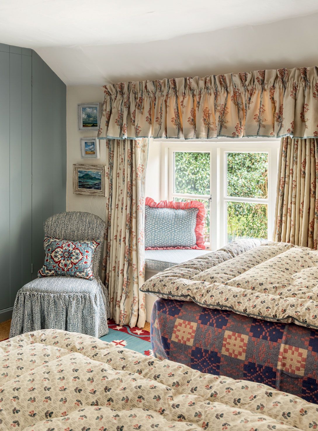 A bedroom in the eaves of Elizabeth Hay's Devon cottage shows that a pelmet can add a bit of oomph to a cottage bedroom...