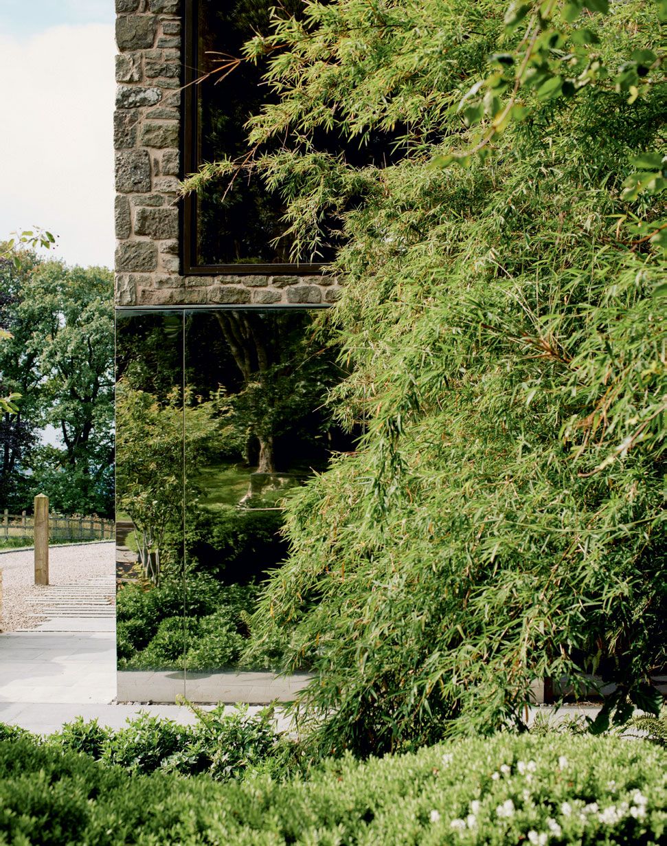 Image may contain Outdoors Garden Arbour Flagstone Plant Tree Building Nature and Vegetation