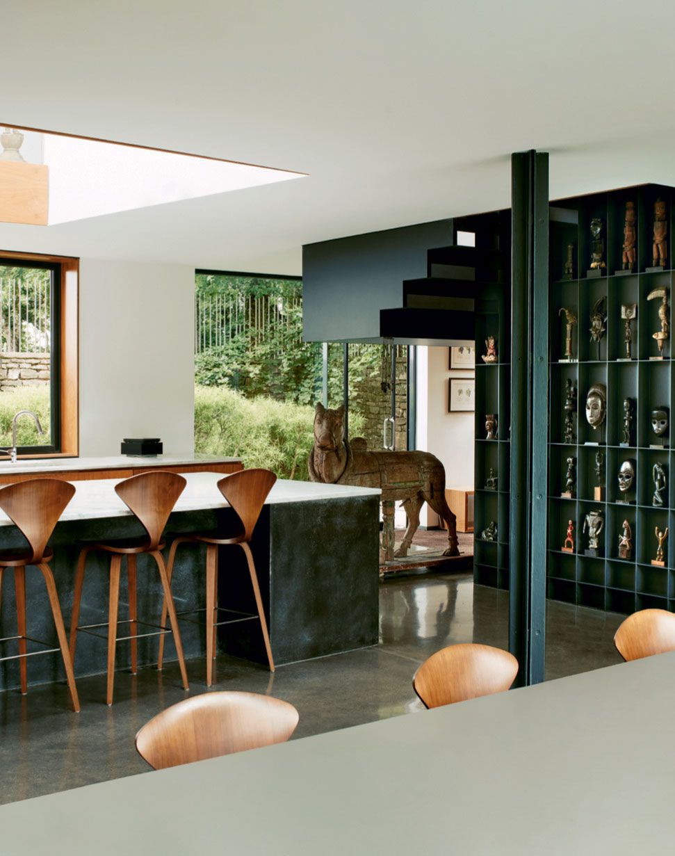 Cherner stools in walnut partner the island. The wooden bull  a representation of the Hindu god Shivas vahana or vehicle...