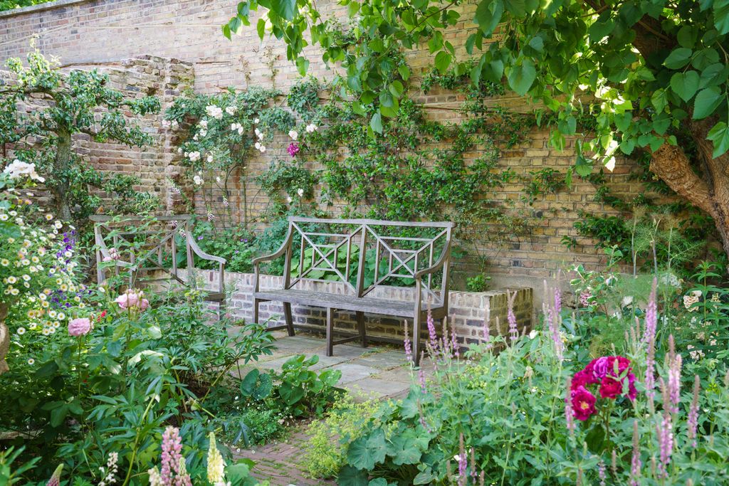 Image may contain Garden Outdoors Arbour Furniture Bench Plant Flower Blossom Vase Pottery Potted Plant and Jar