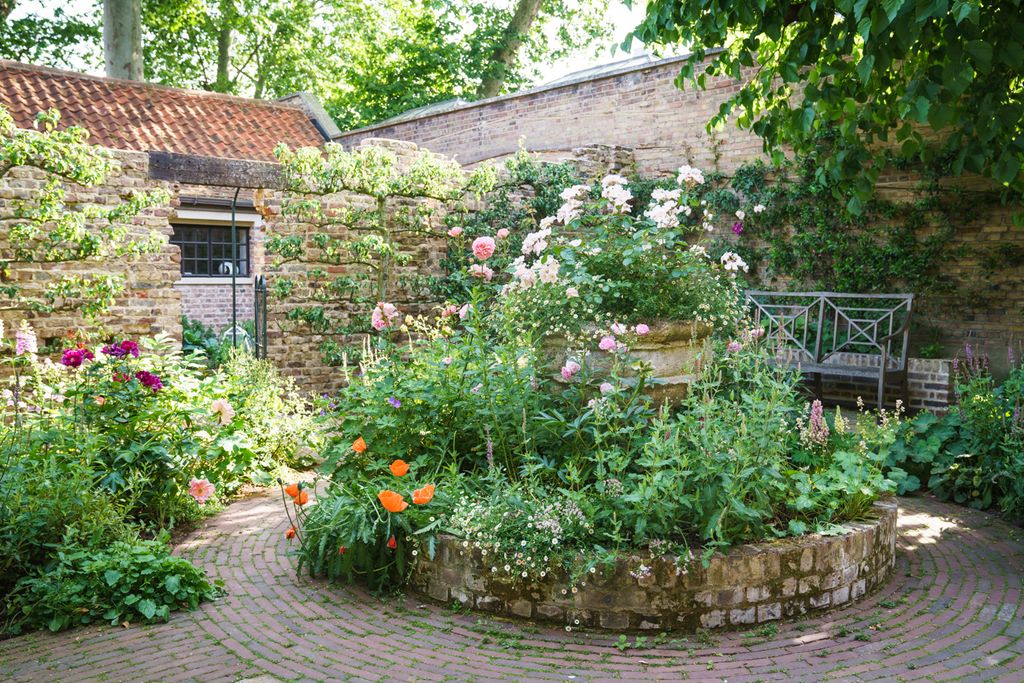 Image may contain Path Walkway Flagstone Outdoors Garden Arbour Sidewalk Pavement Yard and Nature