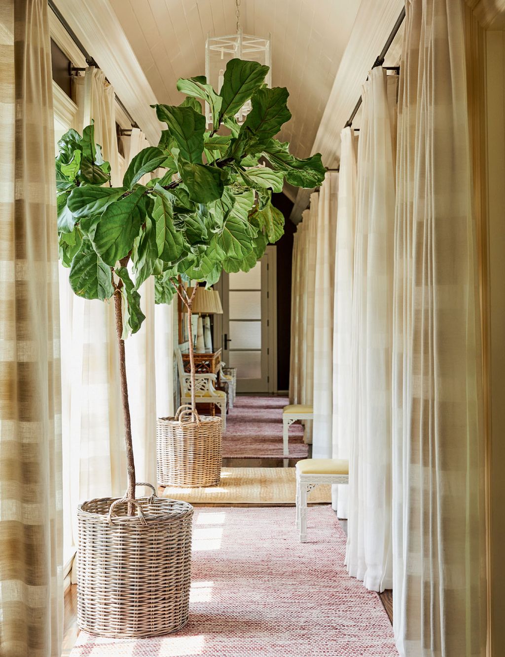 Curtains in simple Larsen linen and a subtly coloured runner make this a calm space to pass through.