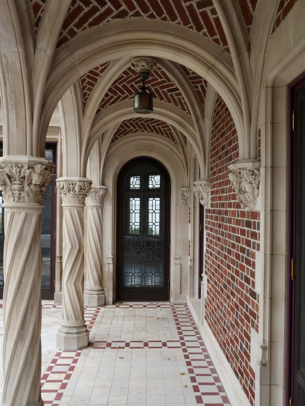 A colonnade runs along one side of the house.