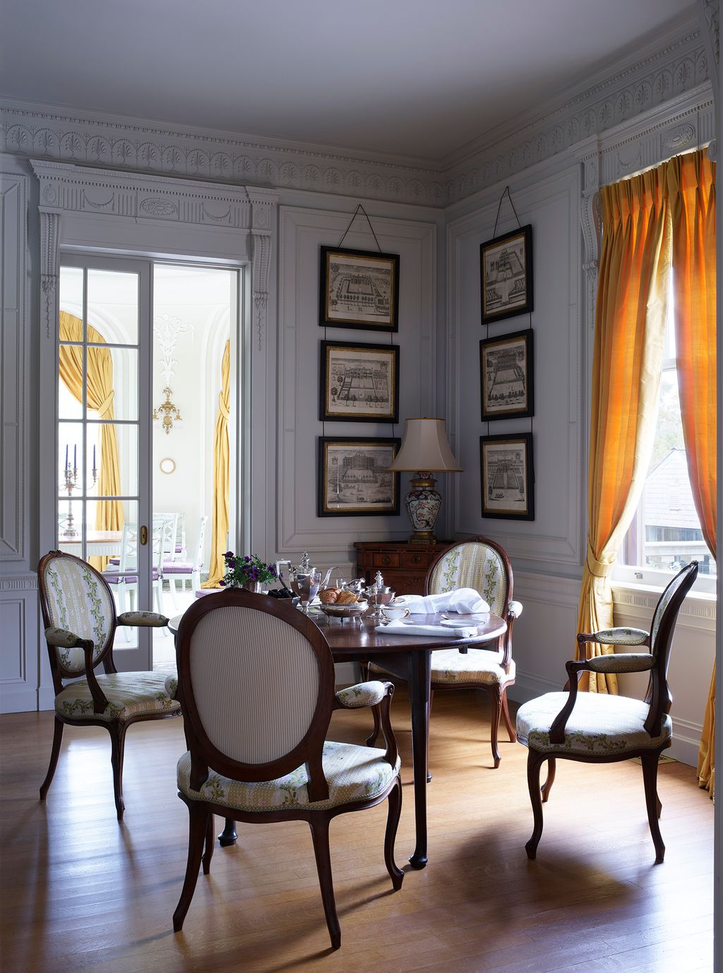 A glazed sliding door separates the Music Room from this sitting room but the spaces are unified by the use of the same...