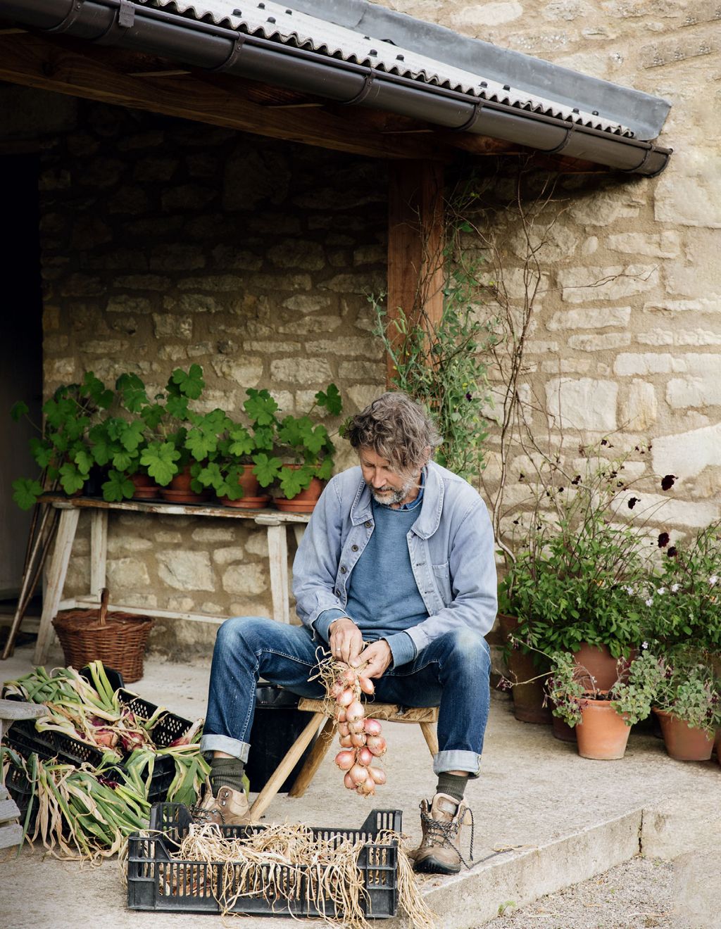 Dan plaits onions by the outdoor kitchen.