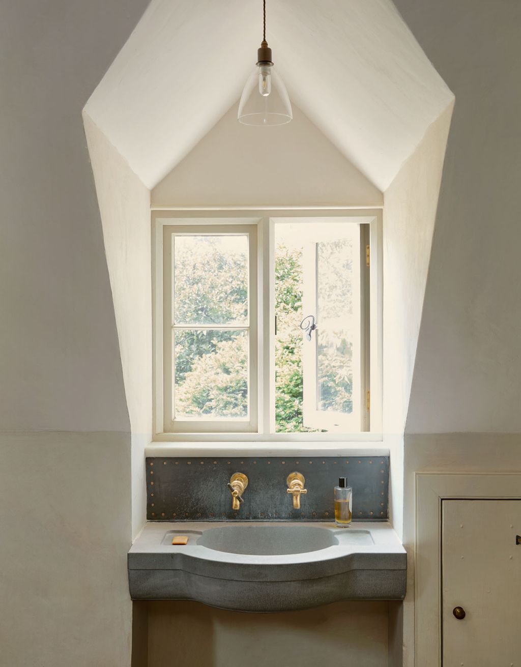 Vintage taps found on Ebay are teamed with a new handmade stone basin and a metal splashback.