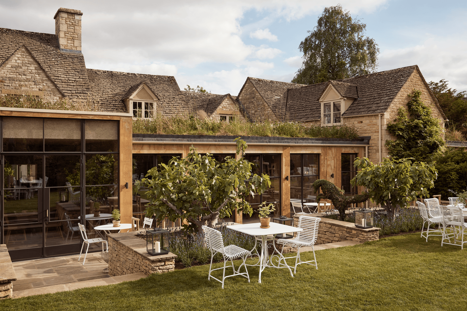 Image may contain Furniture Chair Patio Plant Grass and Roof