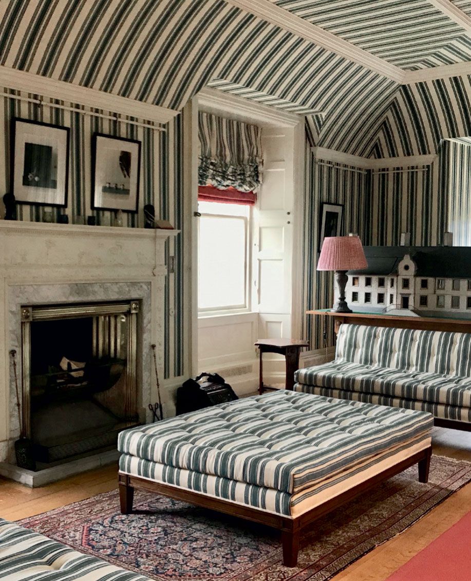 Image may contain Furniture Indoors Room Bedroom Fireplace Interior Design Rug and Bed