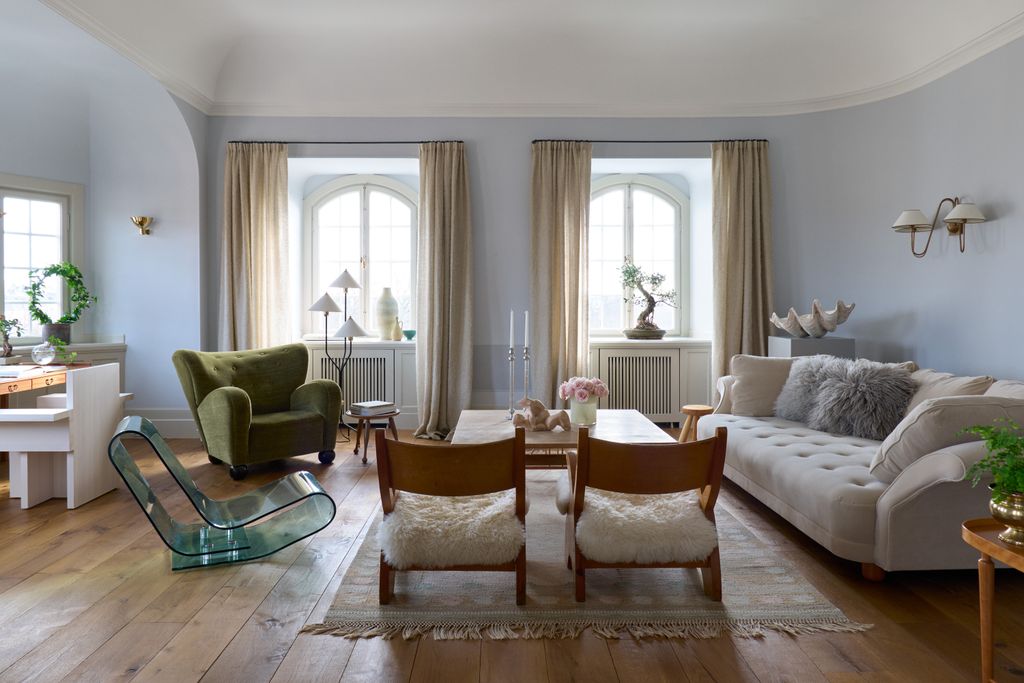 Image may contain Living Room Room Indoors Furniture Couch Flooring Chair Wood Floor Rug and Hardwood