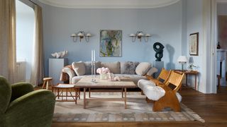 Image may contain Living Room Indoors Room Furniture Table Wood Coffee Table Couch Flooring Rug and Hardwood