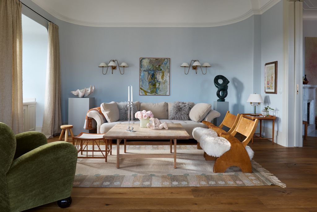 Image may contain Living Room Indoors Room Furniture Table Wood Coffee Table Couch Flooring Rug and Hardwood