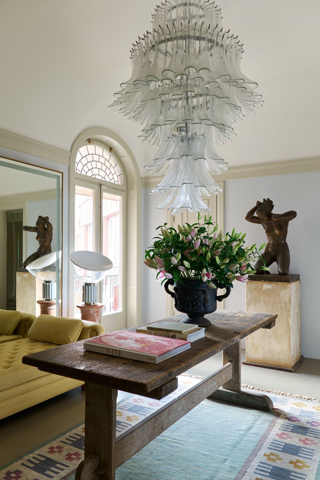 Image may contain Furniture Living Room Room Indoors Table Coffee Table Interior Design Couch Wood and Flooring